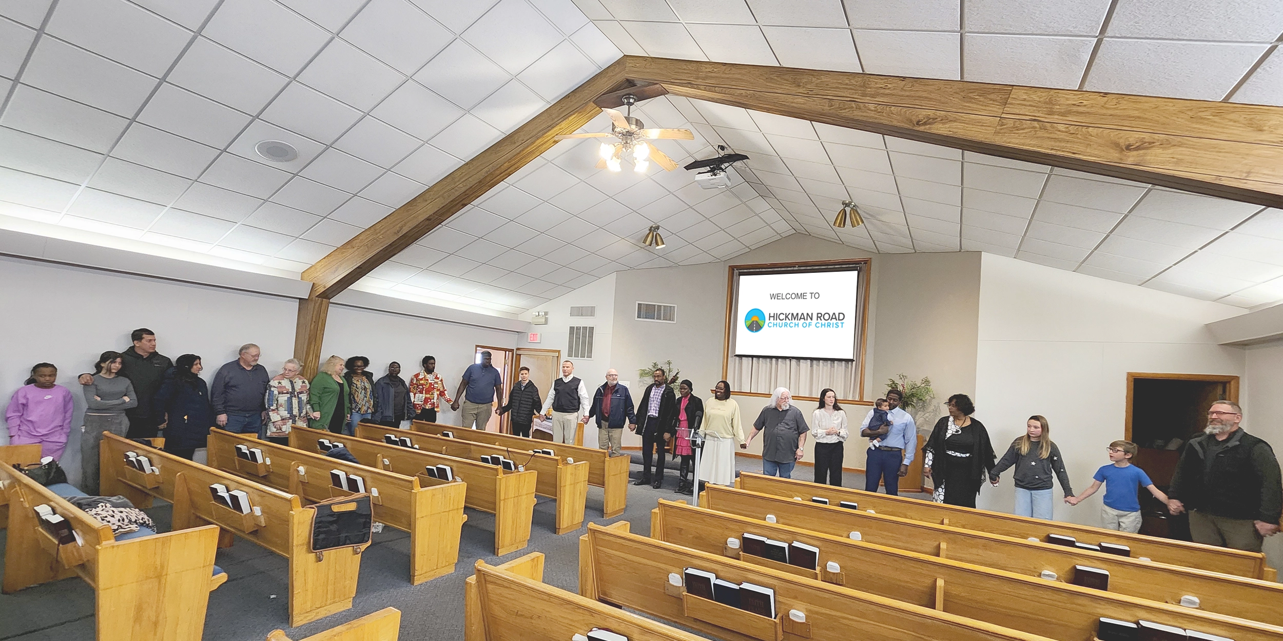 Hickman Road Church of Christ congregation holding hands and praising God